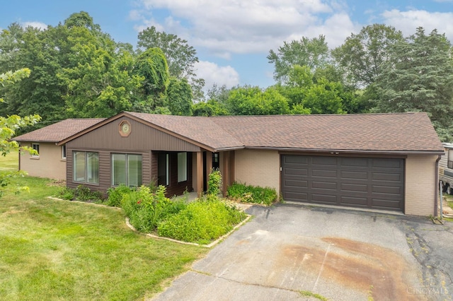 3918 Michael Dr, Union Twp, OH 45255 - view of front of house with asphalt driveway, brick siding, roof with shingles, and a front yard