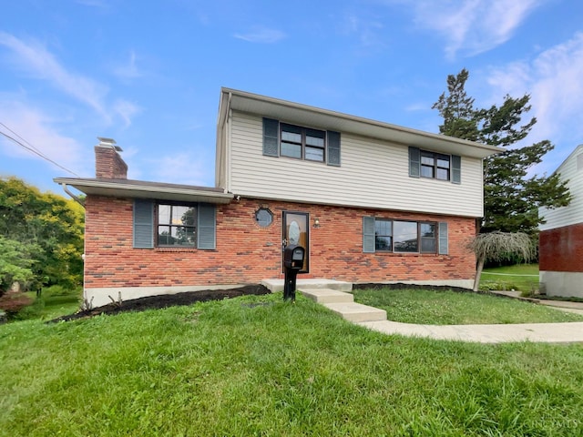 3198 Sunnyhollow Ln, Green Twp, OH 45239 - view of front facade with a chimney, a front lawn, and brick siding