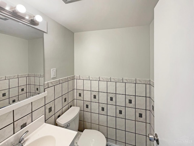 3198 Sunnyhollow Ln, Green Twp, OH 45239 - bathroom with tile walls, a wainscoted wall, and vanity