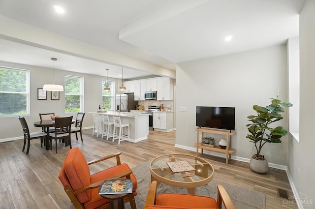 1582 Dixmont Ave, Cincinnati, OH 45207 - living area with light wood-style floors and recessed lighting
