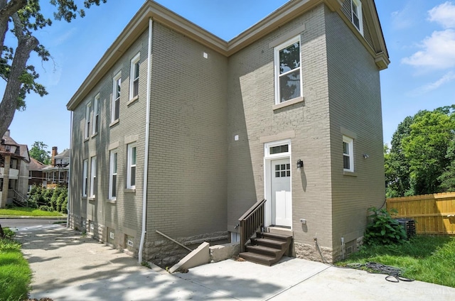 1582 Dixmont Ave, Cincinnati, OH 45207 - view of front facade with entry steps, brick siding, and a patio