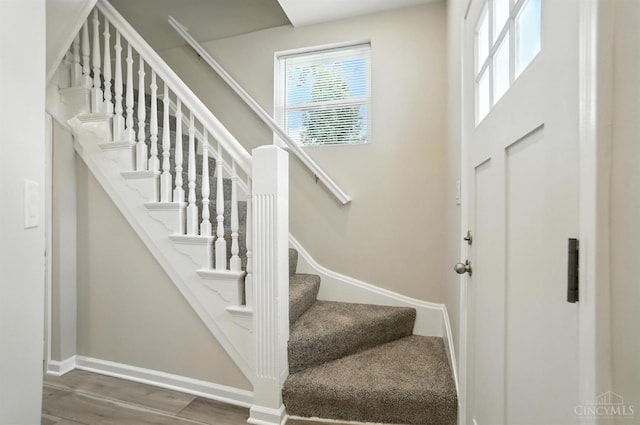 1582 Dixmont Ave, Cincinnati, OH 45207 - stairs with healthy amount of natural light and wood finished floors