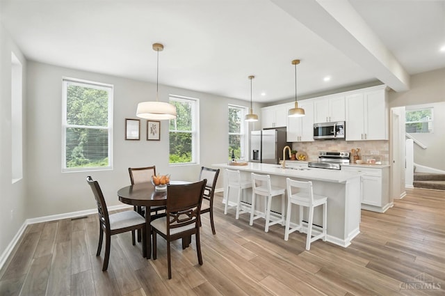 1582 Dixmont Ave, Cincinnati, OH 45207 - dining space featuring light wood finished floors and recessed lighting