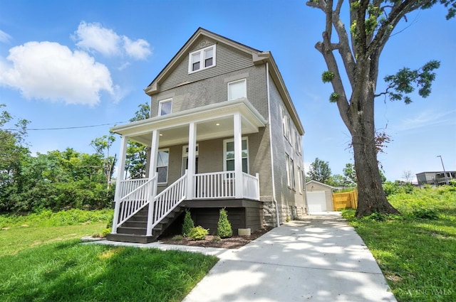 1582 Dixmont Ave, Cincinnati, OH 45207 - american foursquare style home featuring brick siding, covered porch, an outdoor structure, a garage, and a front lawn