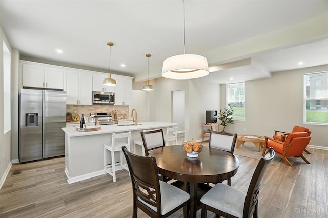 1582 Dixmont Ave, Cincinnati, OH 45207 - dining area featuring light wood-style flooring and recessed lighting
