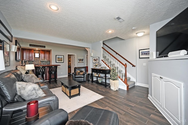 4154 Fieldsedge Dr, Mason, OH 45040 - living room featuring stairway, dark wood-style floors, a textured ceiling, and recessed lighting