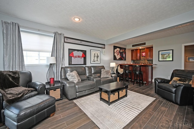 4154 Fieldsedge Dr, Mason, OH 45040 - living area featuring dark wood-type flooring, a textured ceiling, a dry bar, and recessed lighting
