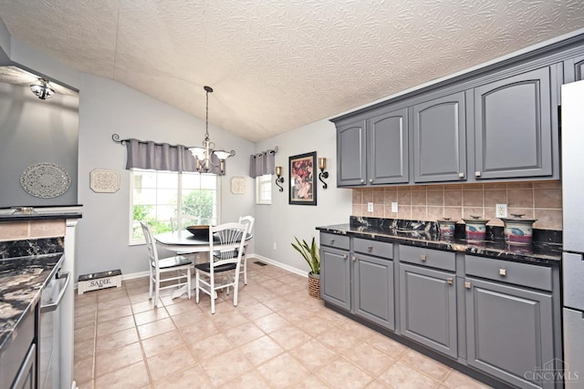 4154 Fieldsedge Dr, Mason, OH 45040 - kitchen featuring backsplash, a chandelier, lofted ceiling, gray cabinetry, and decorative light fixtures