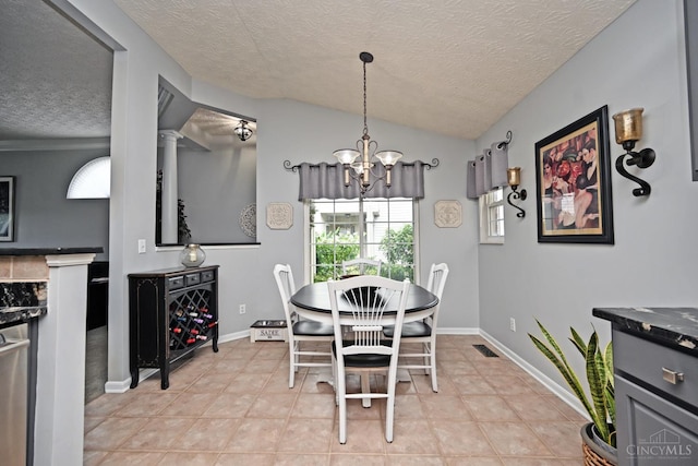 4154 Fieldsedge Dr, Mason, OH 45040 - dining room with a textured ceiling, a chandelier, lofted ceiling, and light tile patterned floors