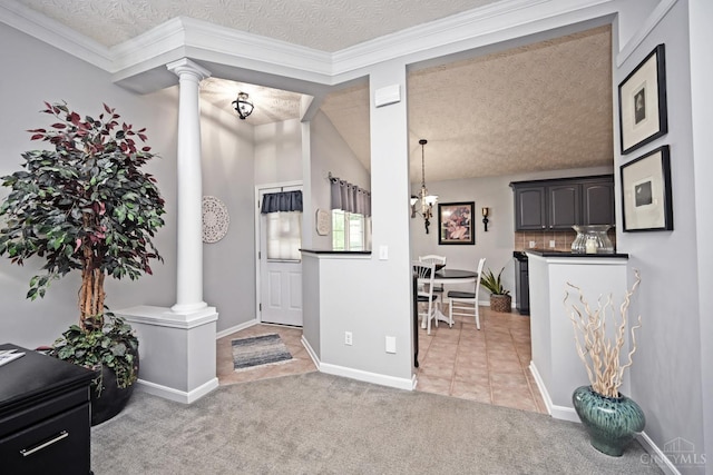 4154 Fieldsedge Dr, Mason, OH 45040 - foyer with ornate columns, a textured ceiling, light tile patterned floors, a chandelier, and light carpet
