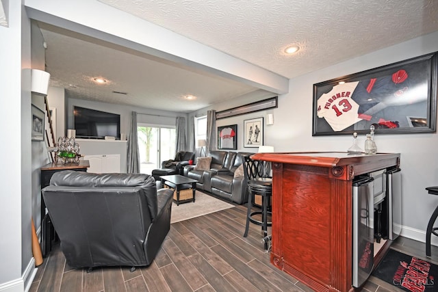 4154 Fieldsedge Dr, Mason, OH 45040 - living room featuring dark wood-style flooring, a textured ceiling, recessed lighting, and a bar