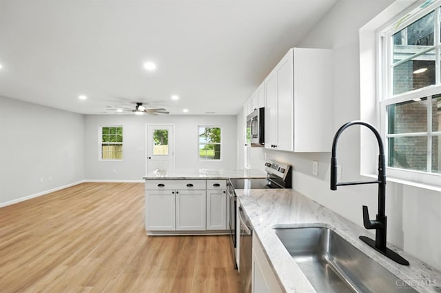 152 N College St, Sabina, OH 45169 - kitchen with appliances with stainless steel finishes, recessed lighting, a ceiling fan, white cabinetry, and a peninsula