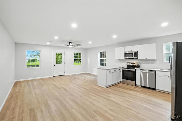 152 N College St, Sabina, OH 45169 - kitchen featuring stainless steel appliances, light countertops, recessed lighting, a peninsula, and white cabinets