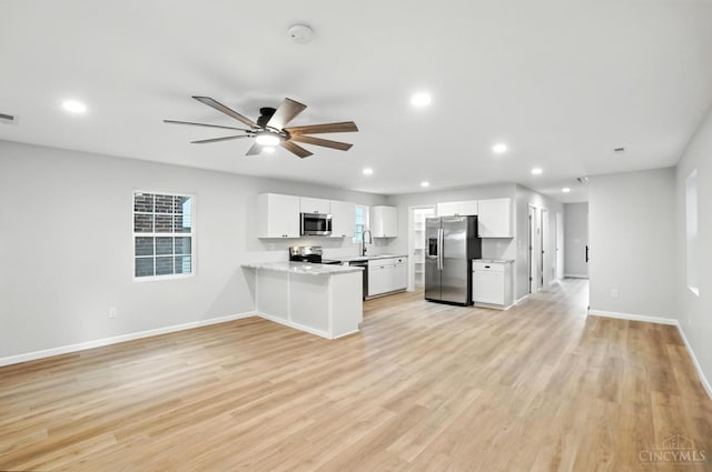 152 N College St, Sabina, OH 45169 - kitchen with appliances with stainless steel finishes, open floor plan, light countertops, recessed lighting, and white cabinets