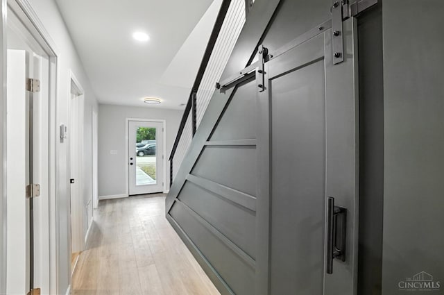 152 N College St, Sabina, OH 45169 - corridor with a barn door, light wood-type flooring, recessed lighting, and stairs