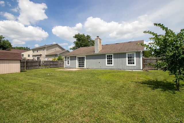 881 Trails End Dr, Liberty Twp, OH 45050 - rear view of property with a fenced backyard, a chimney, an outbuilding, and a patio