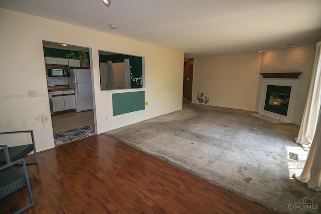 881 Trails End Dr, Liberty Twp, OH 45050 - unfurnished living room with wood finished floors and a fireplace
