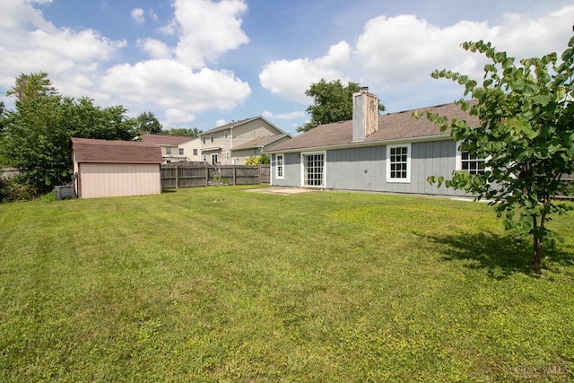 881 Trails End Dr, Liberty Twp, OH 45050 - rear view of house featuring a chimney, a storage shed, and a patio