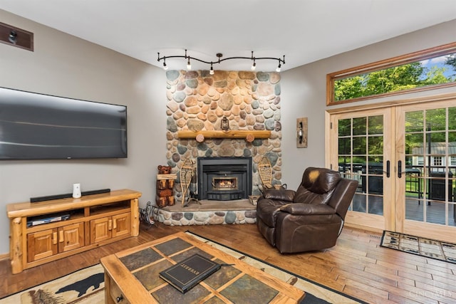 3067 Sugartree Rd, Tate Twp, OH 45106 - living room featuring hardwood / wood-style floors, french doors, rail lighting, and a fireplace