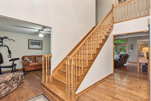 3067 Sugartree Rd, Tate Twp, OH 45106 - staircase featuring wood-type flooring, a towering ceiling, and ceiling fan