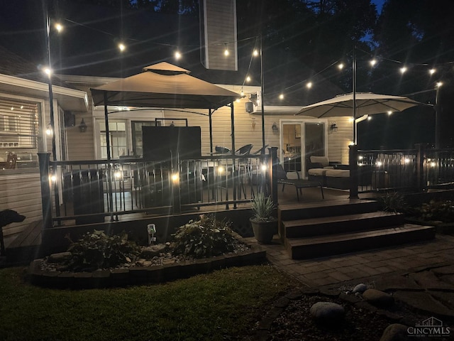 3067 Sugartree Rd, Tate Twp, OH 45106 - back of house at night featuring a deck
