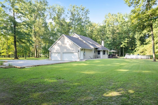 3067 Sugartree Rd, Tate Twp, OH 45106 - view of property exterior with driveway, an attached garage, a yard, a chimney, and an outdoor pool