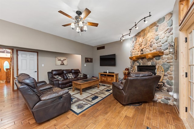 3067 Sugartree Rd, Tate Twp, OH 45106 - living area featuring ceiling fan, light wood-type flooring, rail lighting, and a fireplace