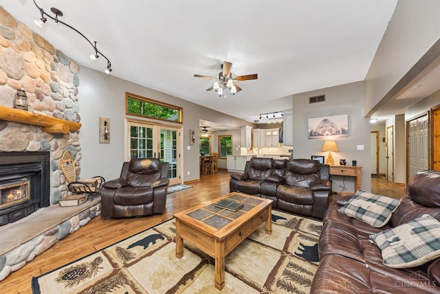 3067 Sugartree Rd, Tate Twp, OH 45106 - living area with a ceiling fan, rail lighting, wood finished floors, and a stone fireplace