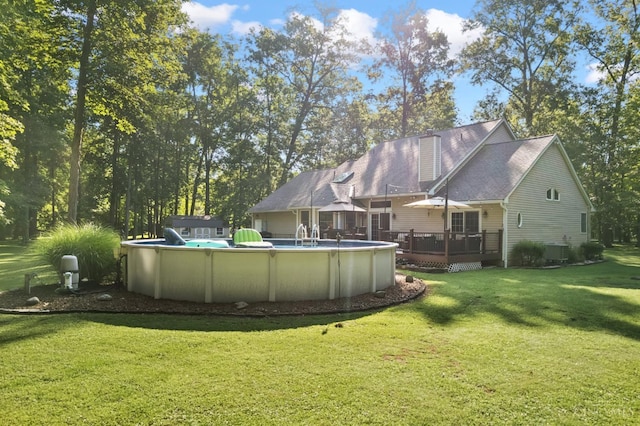 3067 Sugartree Rd, Tate Twp, OH 45106 - rear view of property with a deck, an outdoor pool, a yard, and a chimney