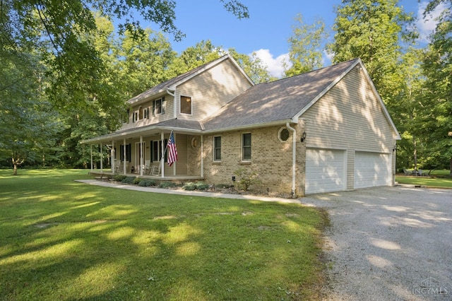 3067 Sugartree Rd, Tate Twp, OH 45106 - view of front of property with covered porch, a garage, driveway, brick siding, and a front lawn