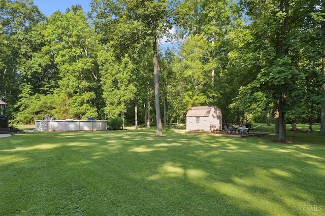 3067 Sugartree Rd, Tate Twp, OH 45106 - view of green lawn featuring a storage unit and a covered pool