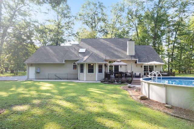 3067 Sugartree Rd, Tate Twp, OH 45106 - back of house featuring a deck, an outdoor pool, a chimney, a gazebo, and a lawn