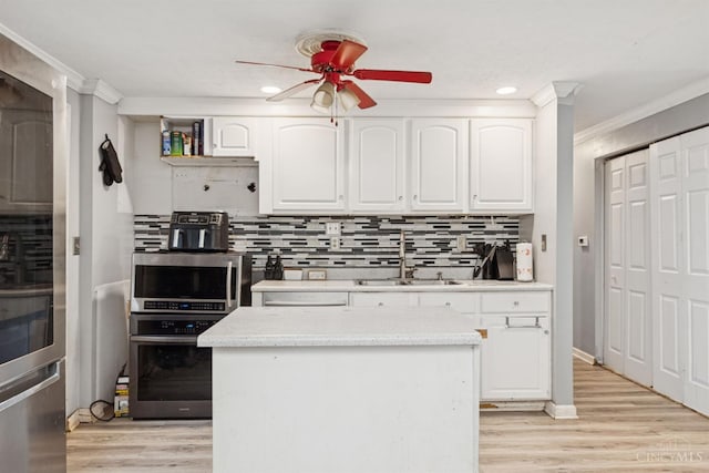 3252 Struble, Colerain Twp, OH 45251 - kitchen with a ceiling fan, white cabinetry, ornamental molding, tasteful backsplash, and light wood-type flooring
