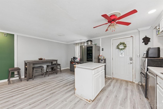 3252 Struble, Colerain Twp, OH 45251 - kitchen featuring light wood-type flooring, light countertops, a ceiling fan, white cabinets, and ornamental molding
