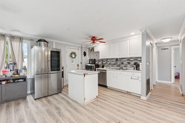 3252 Struble, Colerain Twp, OH 45251 - kitchen featuring appliances with stainless steel finishes, ornamental molding, light countertops, light wood-style floors, and white cabinets