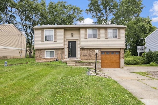 3252 Struble, Colerain Twp, OH 45251 - raised ranch with brick siding, concrete driveway, a garage, and a front yard