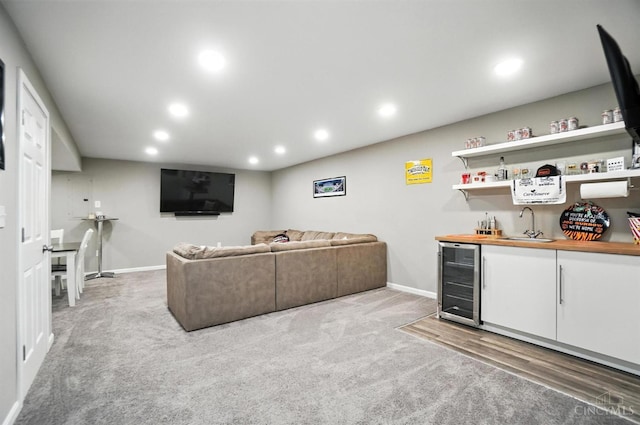 2821 Pine Leaf Ct, Hamilton, OH 45013 - carpeted living room featuring wine cooler, bar with sink, and recessed lighting