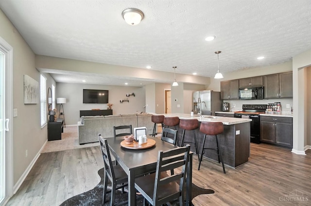 2821 Pine Leaf Ct, Hamilton, OH 45013 - dining room with wood finished floors, a textured ceiling, recessed lighting, and healthy amount of natural light