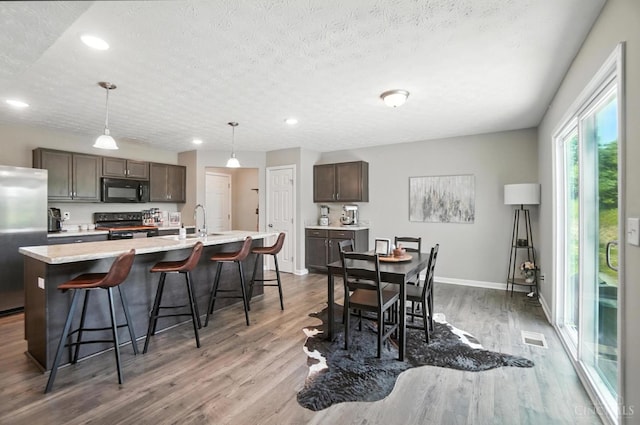 2821 Pine Leaf Ct, Hamilton, OH 45013 - dining space featuring wood finished floors, recessed lighting, and a textured ceiling