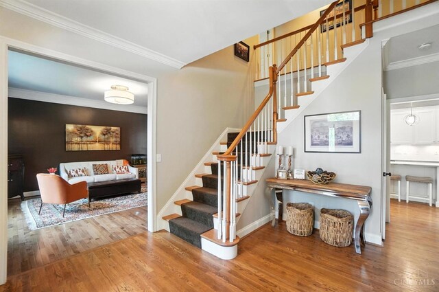 7070 Ravens Run, Anderson Twp, OH 45244 - staircase with wood finished floors and ornamental molding