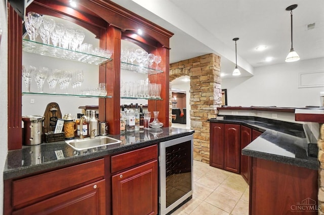 7070 Ravens Run, Anderson Twp, OH 45244 - indoor wet bar with beverage cooler, light tile patterned floors, hanging light fixtures, and ornate columns