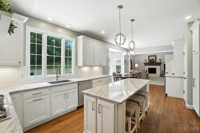 7070 Ravens Run, Anderson Twp, OH 45244 - kitchen featuring stainless steel dishwasher, open floor plan, backsplash, white cabinetry, and recessed lighting