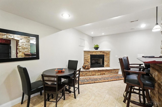 7070 Ravens Run, Anderson Twp, OH 45244 - dining area featuring a fireplace, light tile patterned floors, and recessed lighting