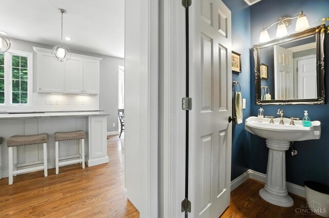 7070 Ravens Run, Anderson Twp, OH 45244 - bathroom featuring wood finished floors and decorative backsplash
