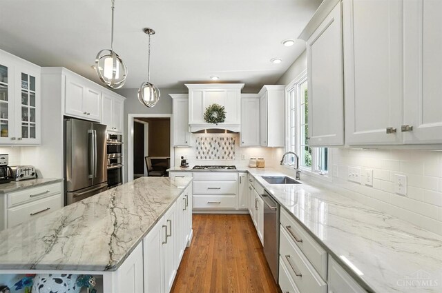 7070 Ravens Run, Anderson Twp, OH 45244 - kitchen with appliances with stainless steel finishes, a center island, white cabinetry, tasteful backsplash, and recessed lighting