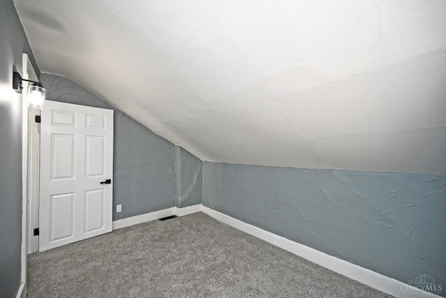 26 Boltin St, Dayton, OH 45403 - bonus room with lofted ceiling, carpet, and a textured wall