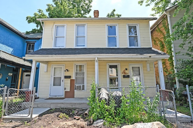 26 Boltin St, Dayton, OH 45403 - view of front of house with covered porch, a gate, and a chimney