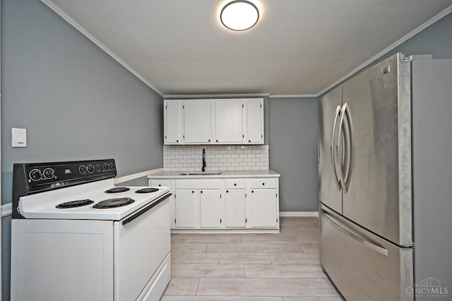 26 Boltin St, Dayton, OH 45403 - kitchen with white range with electric cooktop, freestanding refrigerator, white cabinetry, ornamental molding, and light wood-style floors