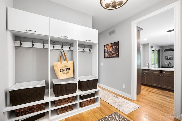 7574 Copper Creek Ln, Colerain Twp, OH 45247 - mudroom featuring light wood-style floors and a chandelier