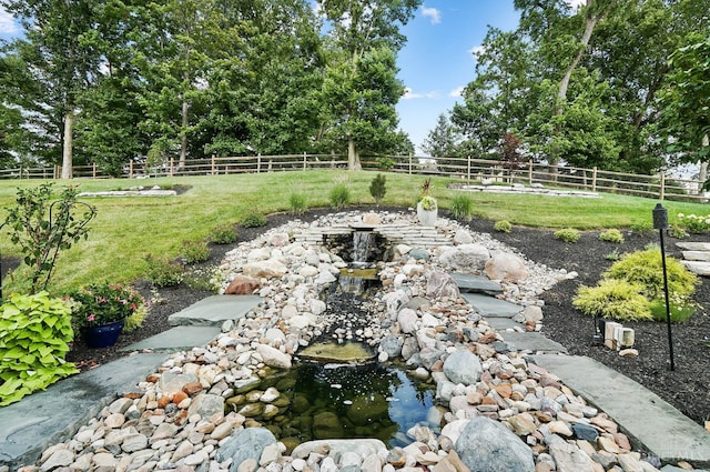 7574 Copper Creek Ln, Colerain Twp, OH 45247 - fenced backyard with a garden pond